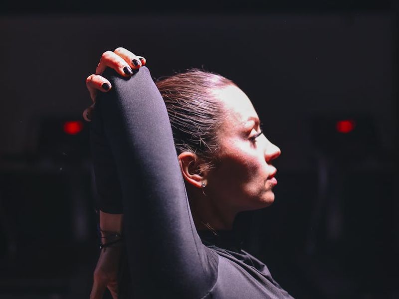 Person doing side stretch in a high-tech gym